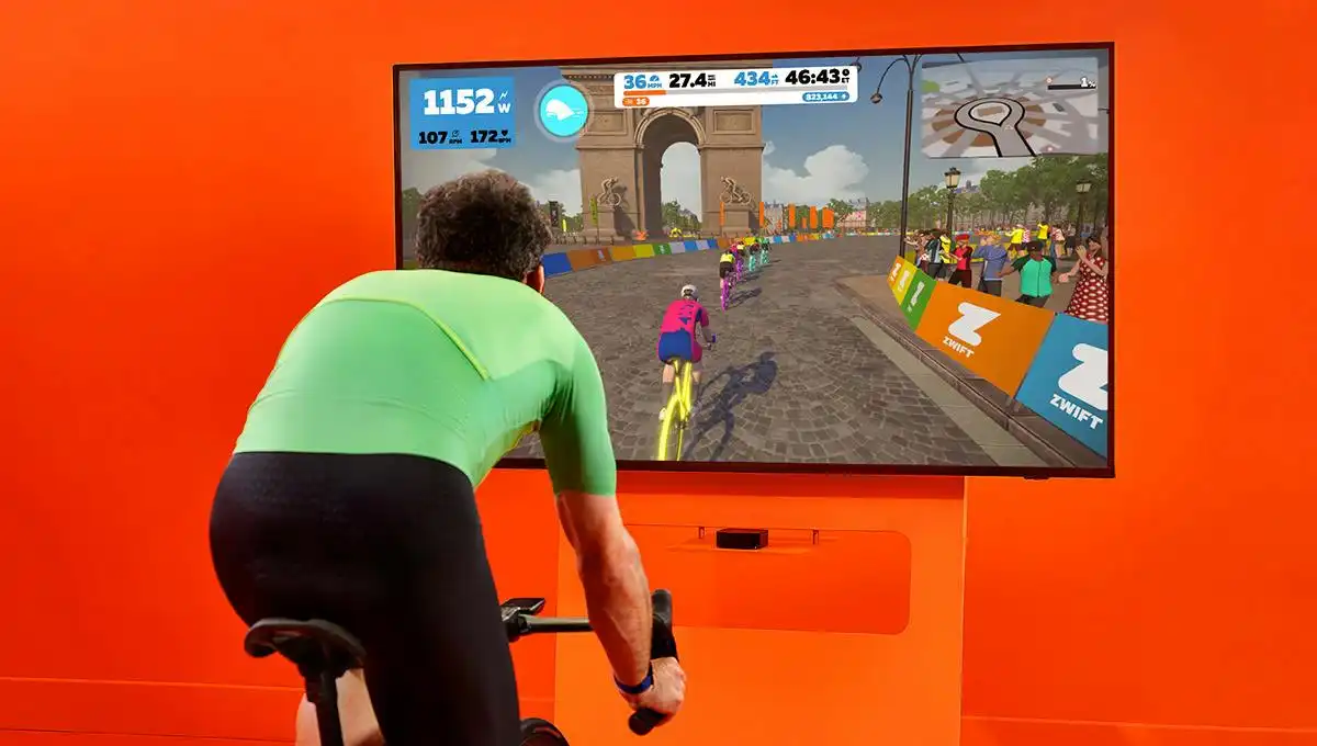 Cyclist riding indoors with Zwift on a screen